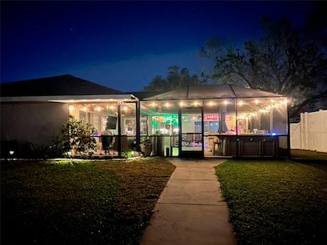 back of house at night with fence