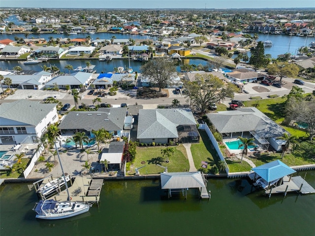 drone / aerial view with a water view and a residential view