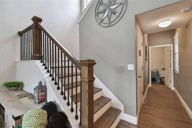 stairs featuring baseboards and wood finished floors