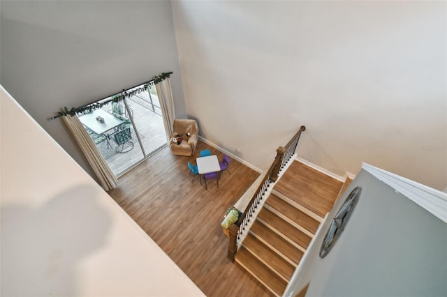 stairway featuring wood finished floors and baseboards