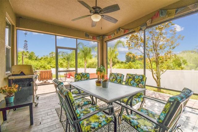 sunroom featuring ceiling fan