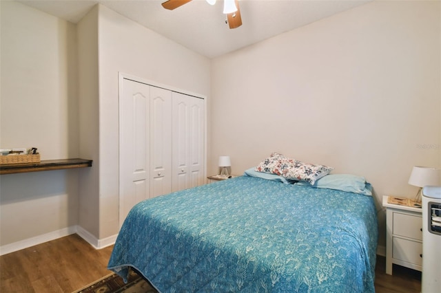 bedroom with a closet, wood finished floors, a ceiling fan, and baseboards