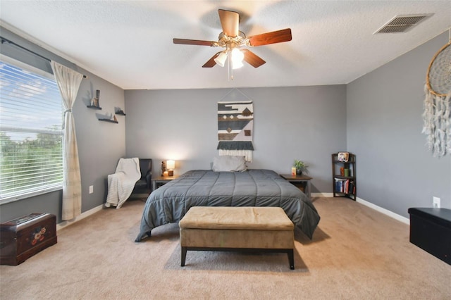 bedroom with carpet floors, baseboards, visible vents, and a textured ceiling