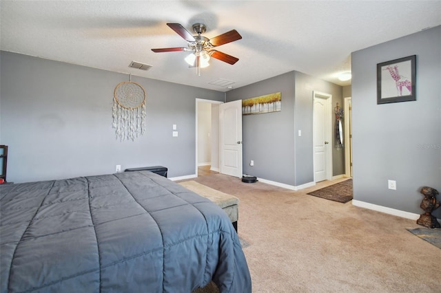 carpeted bedroom with baseboards, visible vents, ceiling fan, and a textured ceiling