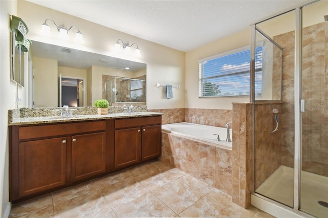 full bath featuring a sink, a shower stall, double vanity, and a bath