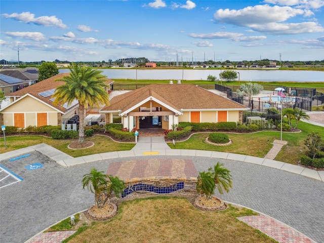 view of front of home featuring uncovered parking and a water view