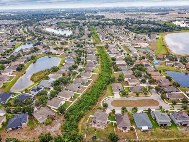 birds eye view of property with a residential view and a water view