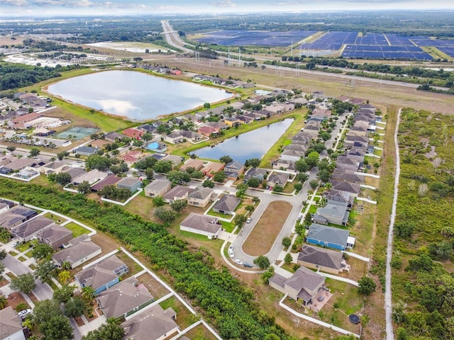 birds eye view of property with a residential view and a water view