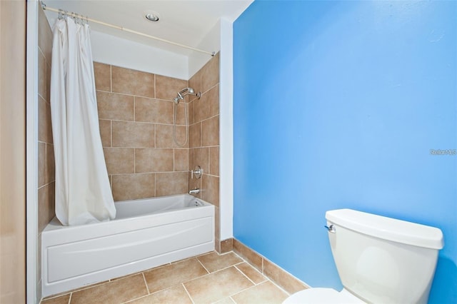 bathroom with shower / bath combination with curtain, toilet, and tile patterned floors