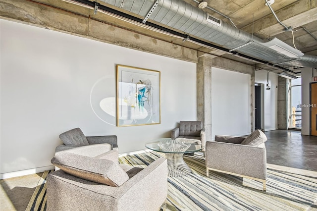 sitting room featuring visible vents and concrete floors