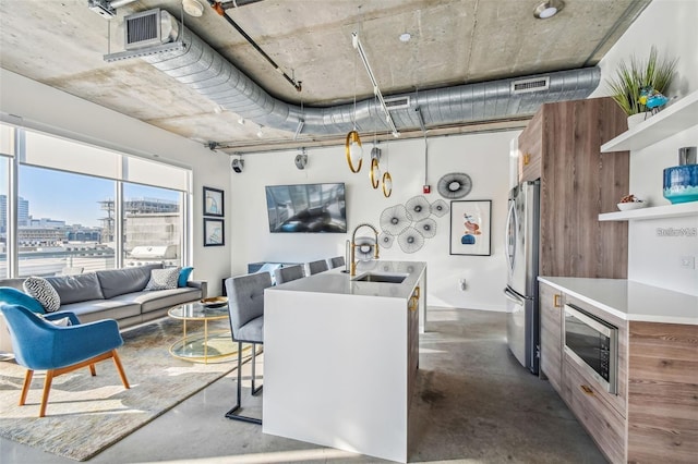 kitchen with a sink, appliances with stainless steel finishes, a view of city, open shelves, and finished concrete floors