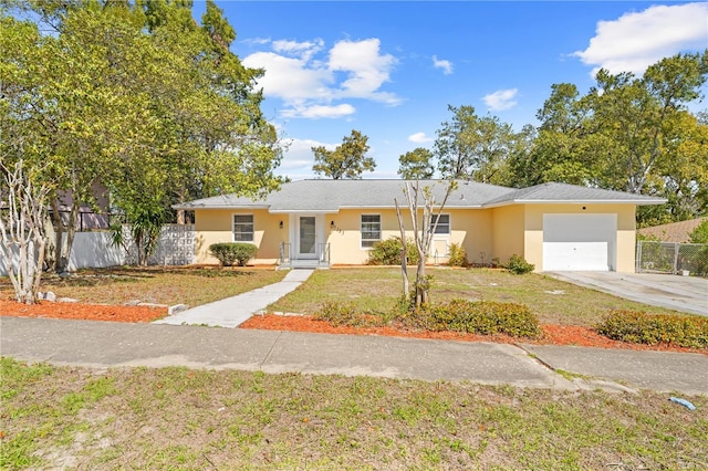 ranch-style house featuring a garage, a front yard, fence, and stucco siding