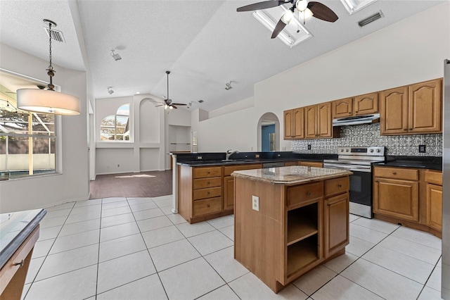 kitchen with visible vents, under cabinet range hood, stainless steel electric range, and light tile patterned floors