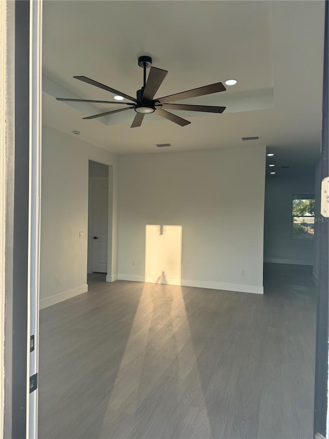 empty room featuring visible vents, recessed lighting, baseboards, and wood finished floors