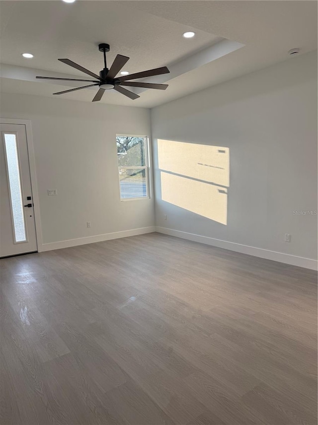 unfurnished room with recessed lighting, baseboards, and wood finished floors