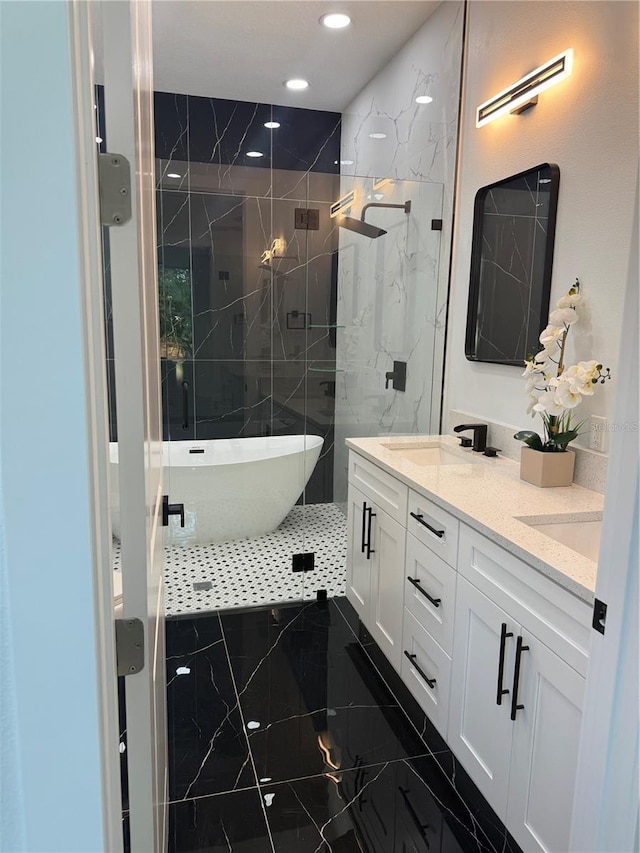 full bathroom with marble finish floor, a sink, a marble finish shower, double vanity, and a freestanding bath