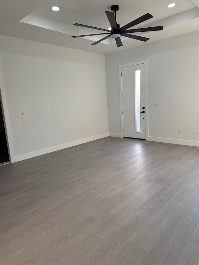 spare room with recessed lighting, wood finished floors, baseboards, and ceiling fan