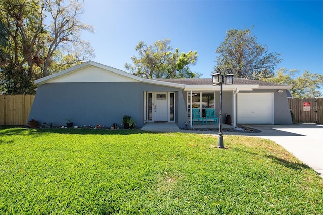 single story home with fence, a front lawn, and stucco siding