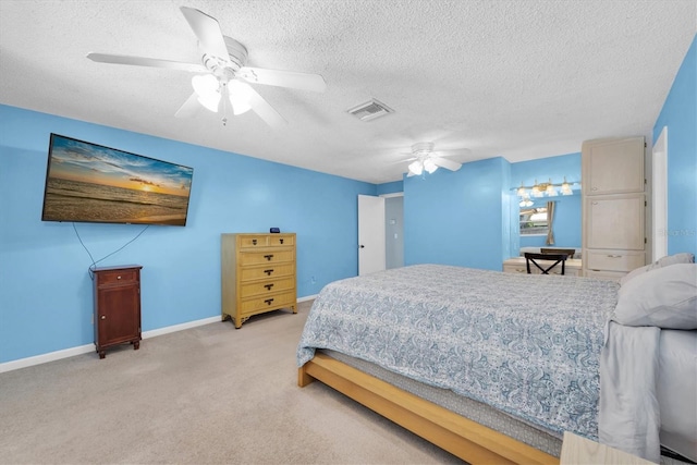 carpeted bedroom with a ceiling fan, baseboards, visible vents, and a textured ceiling