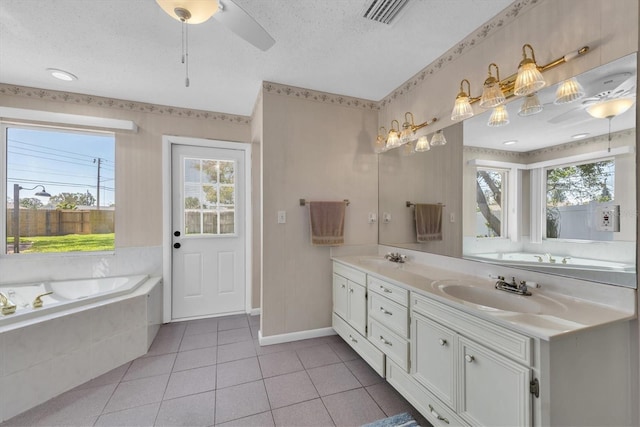 bathroom featuring double vanity, a sink, a wealth of natural light, and tile patterned floors