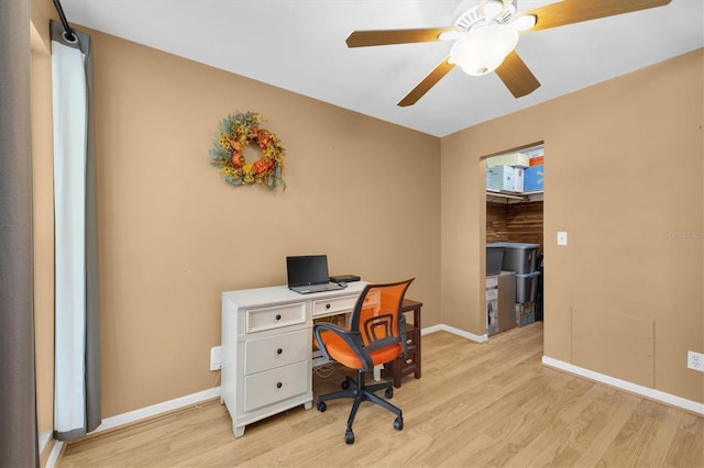 office area featuring ceiling fan, light wood-style flooring, and baseboards