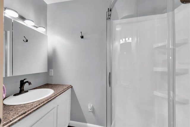 bathroom with a stall shower and vanity