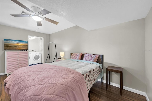 bedroom with ceiling fan, washer and clothes dryer, baseboards, and wood finished floors