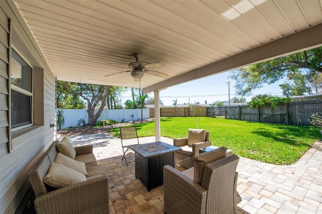 view of patio featuring an outdoor fire pit, a fenced backyard, and a ceiling fan