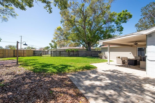 view of yard with a patio, fence private yard, and a ceiling fan