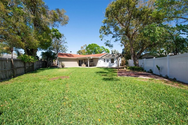 view of yard with a patio area and a fenced backyard