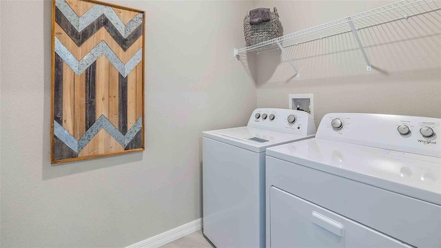 laundry area featuring laundry area, baseboards, and washer and clothes dryer