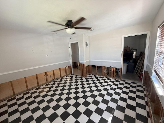 unfurnished room with a ceiling fan and visible vents