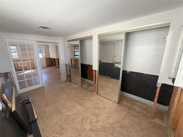 bedroom featuring two closets and visible vents