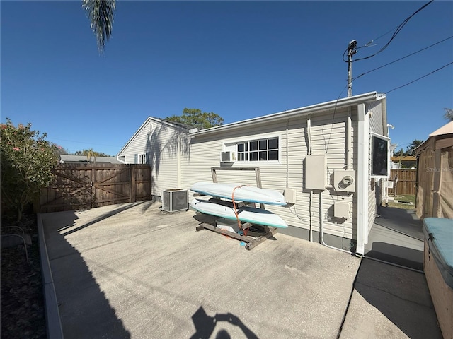 back of house with central AC, a patio, and a fenced backyard