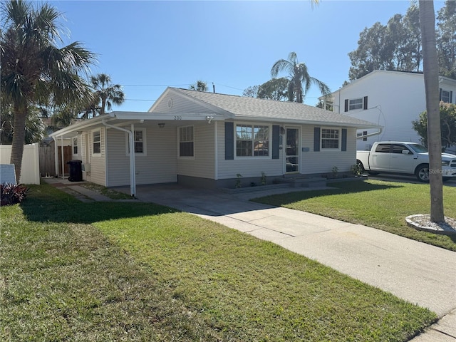 ranch-style home with a carport, concrete driveway, fence, and a front lawn