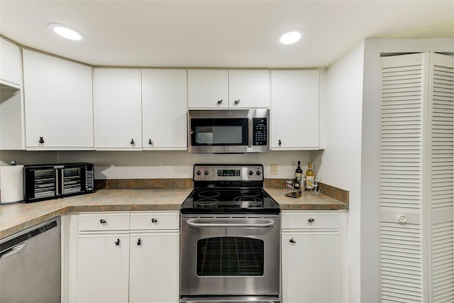 kitchen with stainless steel appliances, recessed lighting, and white cabinets