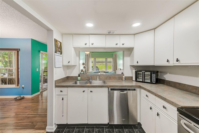 kitchen with visible vents, dishwasher, a sink, and white cabinetry