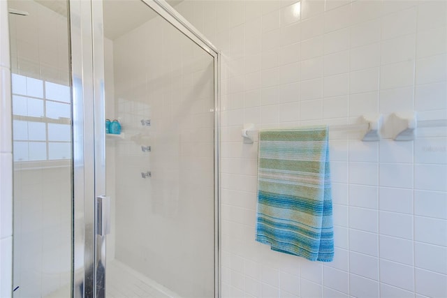 full bath featuring a shower stall