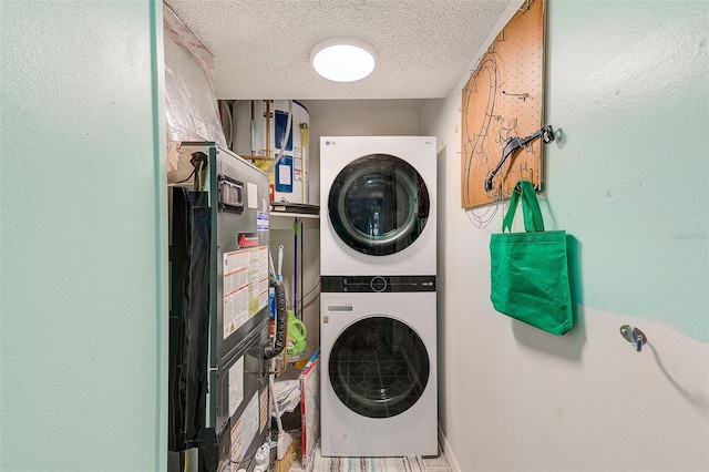 laundry room with laundry area, a textured ceiling, and stacked washer / drying machine