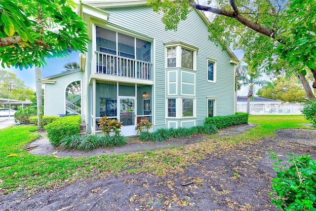 back of property with a sunroom