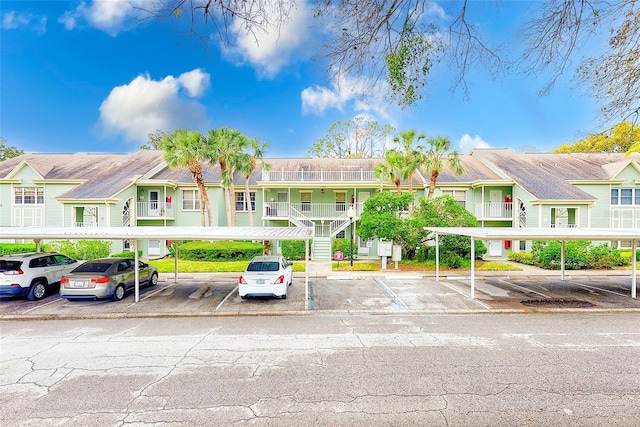 view of property with a residential view and covered and uncovered parking