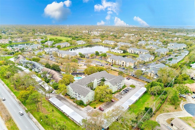 drone / aerial view with a residential view and a water view