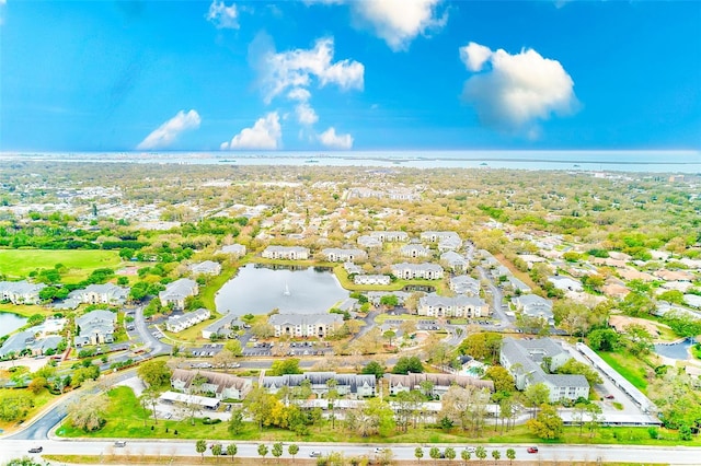 birds eye view of property with a water view and a residential view