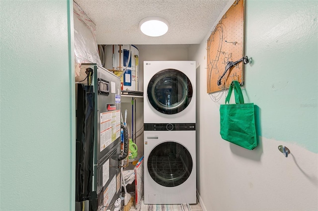 300 Promenade Dr Unit 106, Dunedin, FL 34698 - laundry room with stacked washer and clothes dryer and a textured ceiling