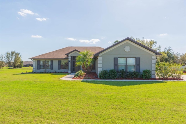 single story home with stucco siding and a front yard