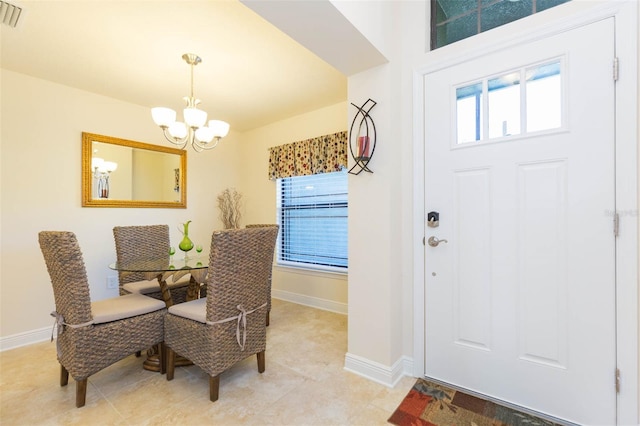 dining area featuring a healthy amount of sunlight, baseboards, and a chandelier