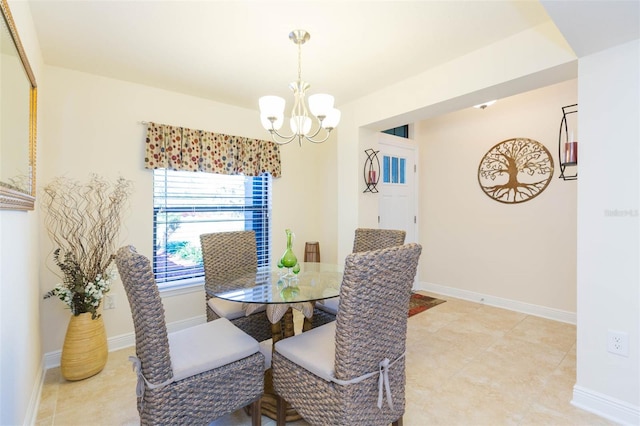 dining room featuring baseboards and a chandelier
