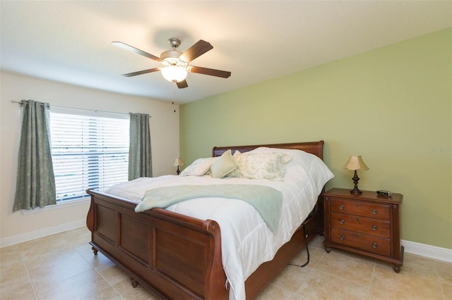bedroom with light tile patterned floors, baseboards, and a ceiling fan