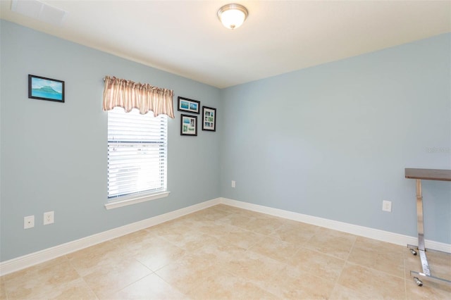 spare room featuring visible vents and baseboards
