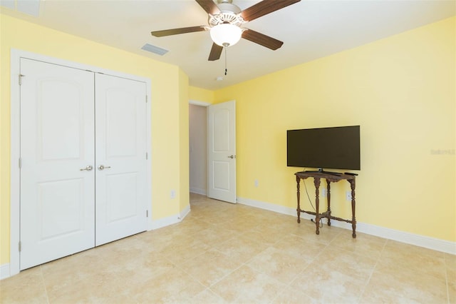 unfurnished bedroom featuring baseboards, visible vents, ceiling fan, and a closet